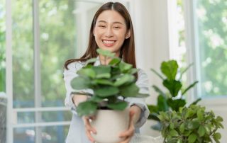 Lady giving mom a housepalnt for mothers day - Top Houseplants to Gift Mom Instead of Flowers