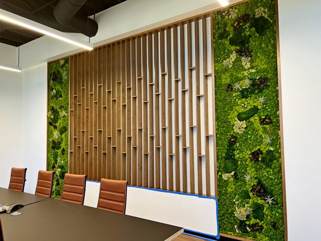 Modern boardroom with custom moss wall.