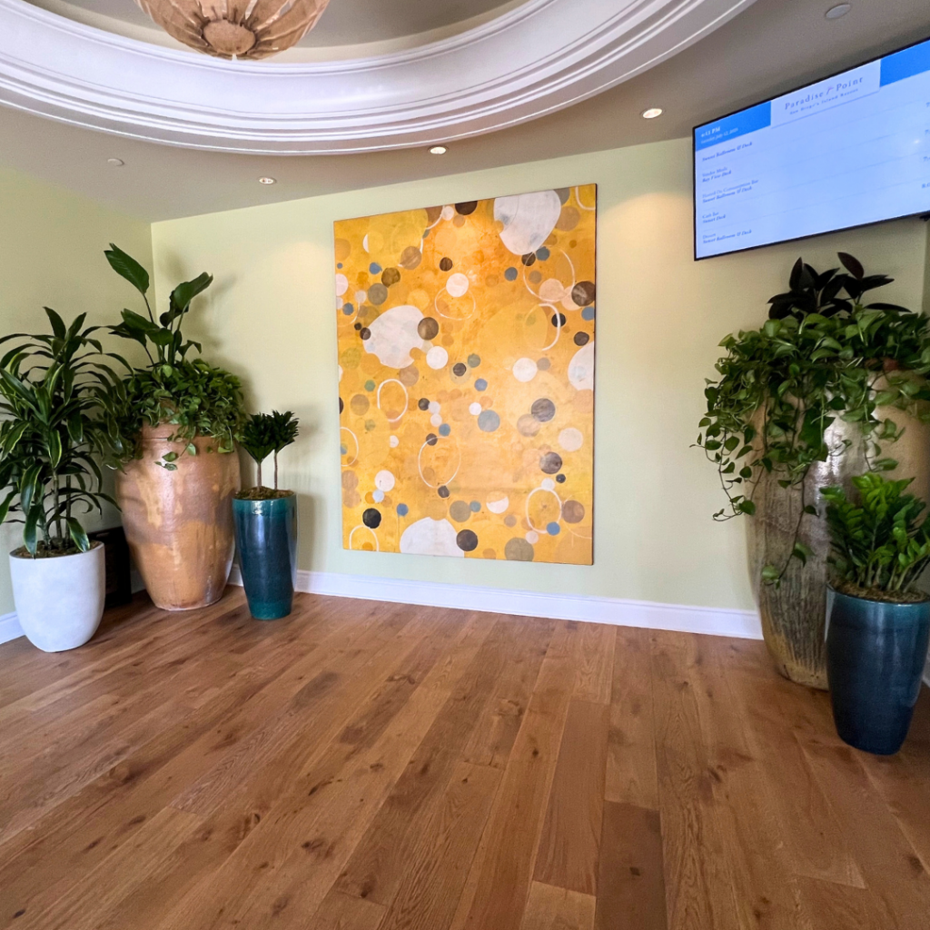 Customized plants for hotel lobby display, surrounding a piece of art.